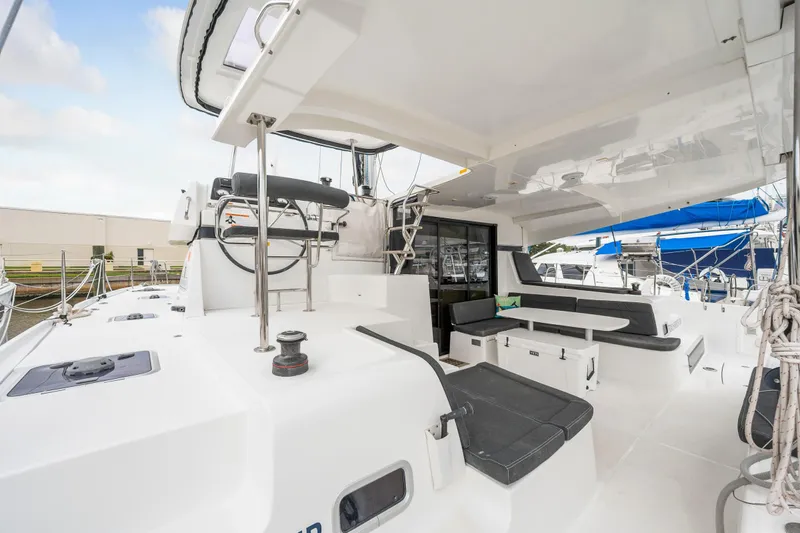 Aquaholic Yacht Photos Pics 2018 Lagoon 42 catamaran cockpit with seating and helm station.