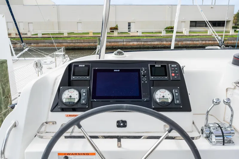 Aquaholic Yacht Photos Pics Lagoon 42 2018 yacht helm station with navigation instruments and steering wheel.