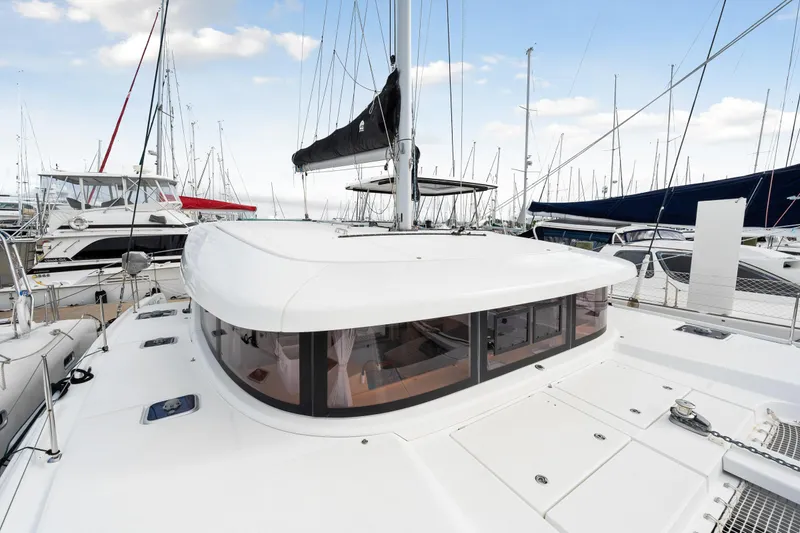 Aquaholic Yacht Photos Pics Lagoon 42 catamaran 2018 model docked at marina with other boats.