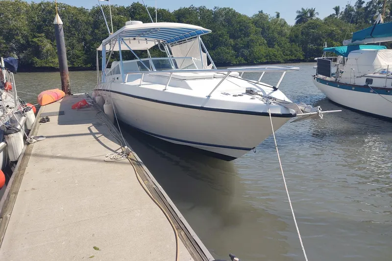 El Falcon Yacht Photos Pics 2008 Contender 35 Express Side Console boat docked by the river.
