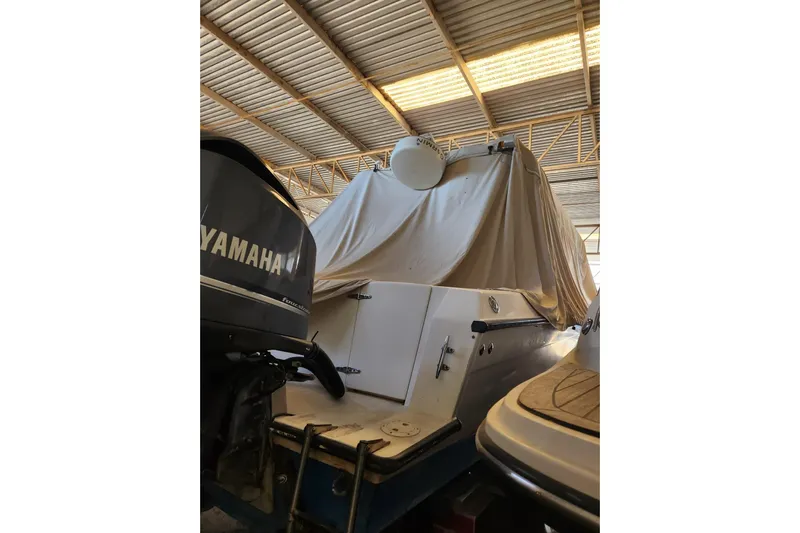 El Falcon Yacht Photos Pics 2008 Contender 35 Express Side Console boat covered in storage with Yamaha engine.