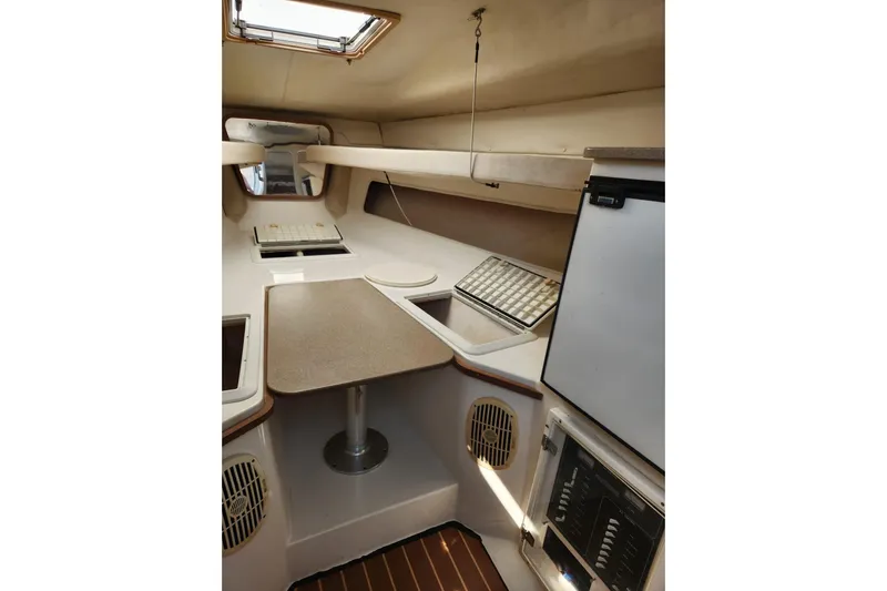 El Falcon Yacht Photos Pics 2008 Contender 35 Express Side Console interior with table, storage, and appliances.