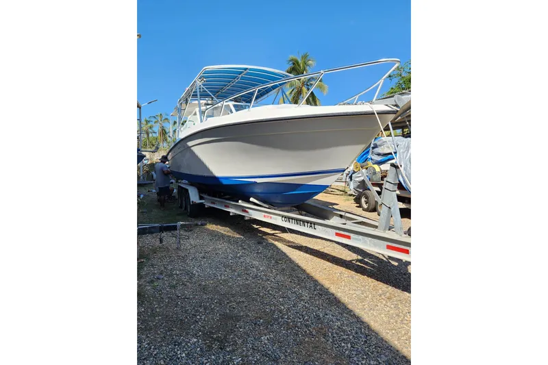 El Falcon Yacht Photos Pics 2008 Contender 35 Express Side Console boat on trailer, sunny day, palm trees in background.