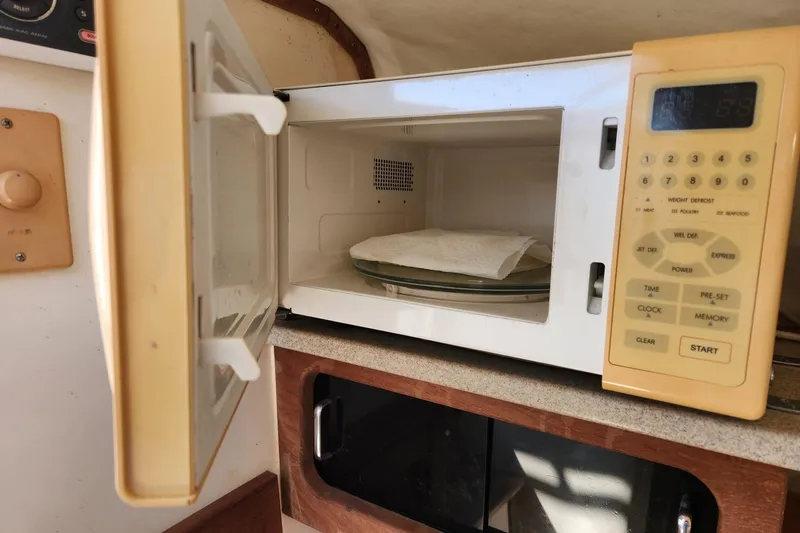 El Falcon Yacht Photos Pics Open microwave in 2008 Contender 35 Express Side Console boat interior.