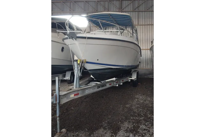 El Falcon Yacht Photos Pics 2008 Contender 35 Express Side Console boat on trailer in storage facility.