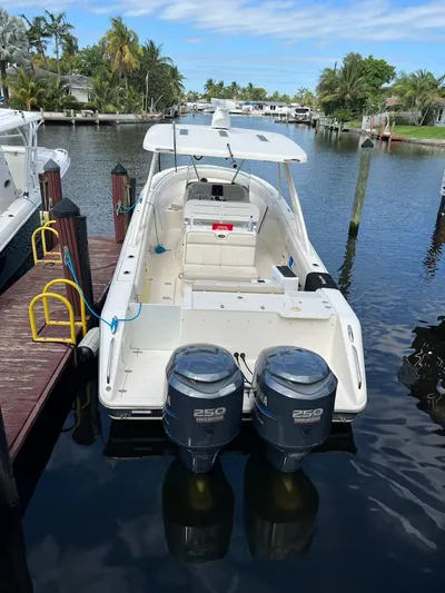 Relentless Yacht Photos Pics 2009 Pursuit S 310 Sport boat docked with twin 250 horsepower engines.