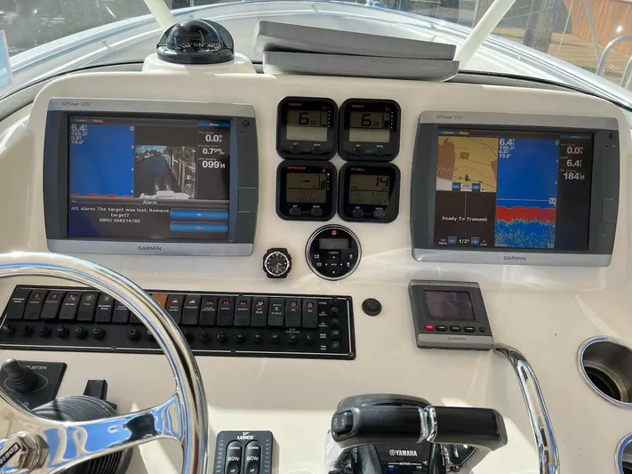 Relentless Yacht Photos Pics 2009 Pursuit S 310 Sport boat dashboard with Garmin navigation screens and Yamaha controls.