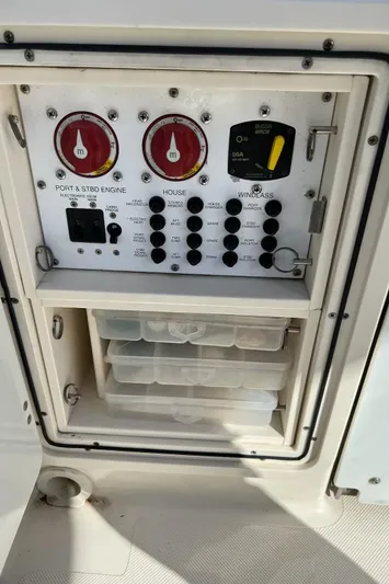 Relentless Yacht Photos Pics Control panel of a 2009 Pursuit S 310 Sport boat with storage compartments.