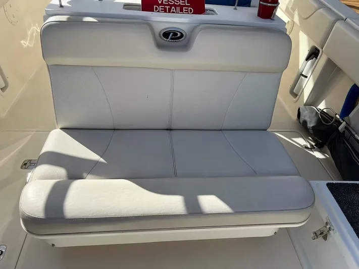 Relentless Yacht Photos Pics 2009 Pursuit S 310 Sport boat with white cushioned seating.