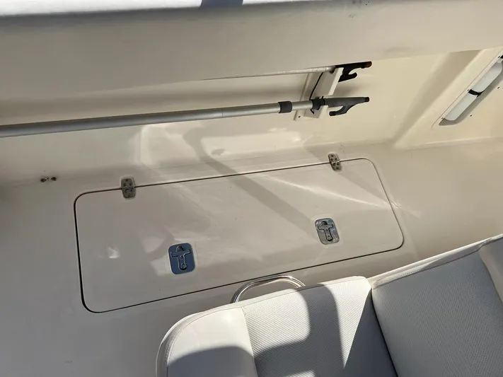 Relentless Yacht Photos Pics 2009 Pursuit S 310 Sport boat storage compartment and seating area.