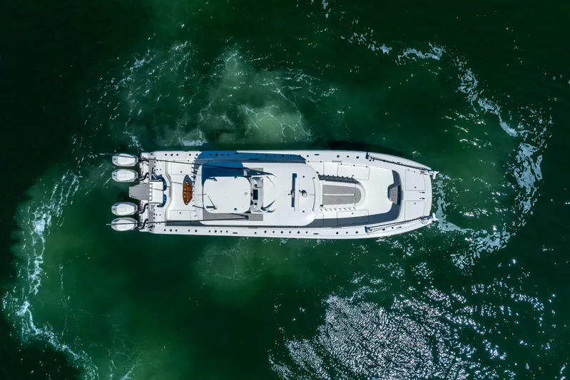  Yacht Photos Pics Aerial view of 2023 Freeman 43 yacht cruising in green ocean waters.