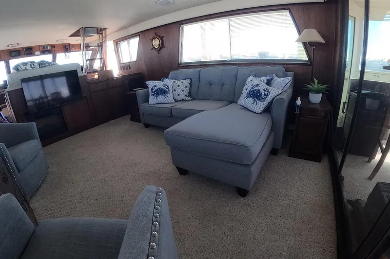 Saint Paul Yacht Photos Pics Luxurious interior of 1987 Hatteras 54 Motor Yacht with elegant seating and nautical decor.