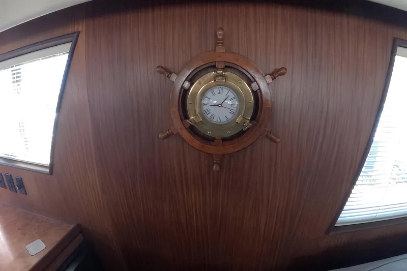 Saint Paul Yacht Photos Pics Wall-mounted nautical clock on 1987 Hatteras 54 Motor Yacht interior.