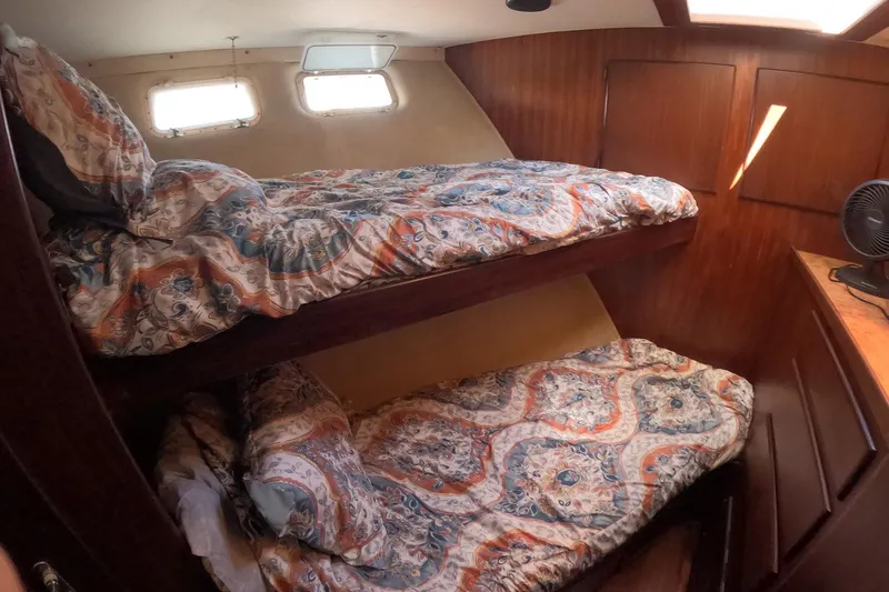Saint Paul Yacht Photos Pics 1987 Hatteras 54 Motor Yacht cabin with bunk beds and patterned bedding.