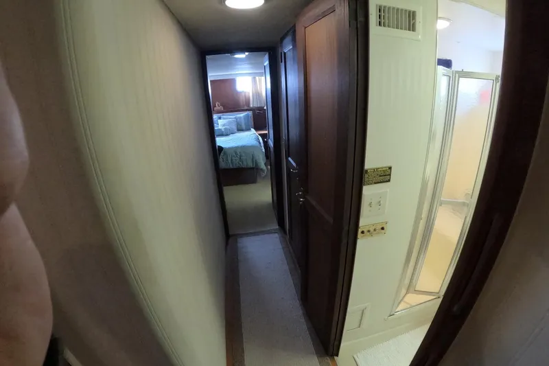 Saint Paul Yacht Photos Pics Narrow hallway in 1987 Hatteras 54 Motor Yacht with bedroom and bathroom view.