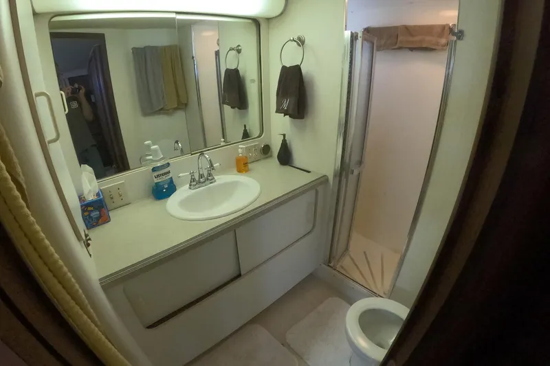 Saint Paul Yacht Photos Pics Bathroom interior of 1987 Hatteras 54 Motor Yacht with sink, mirror, and shower.