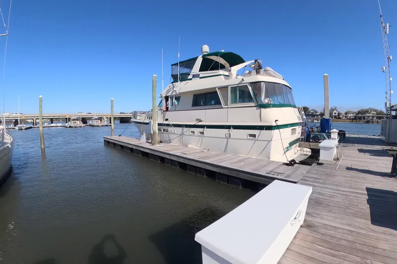 Saint Paul Yacht Photos Pics 1987 Hatteras 54 Motor Yacht docked at marina under clear blue sky.