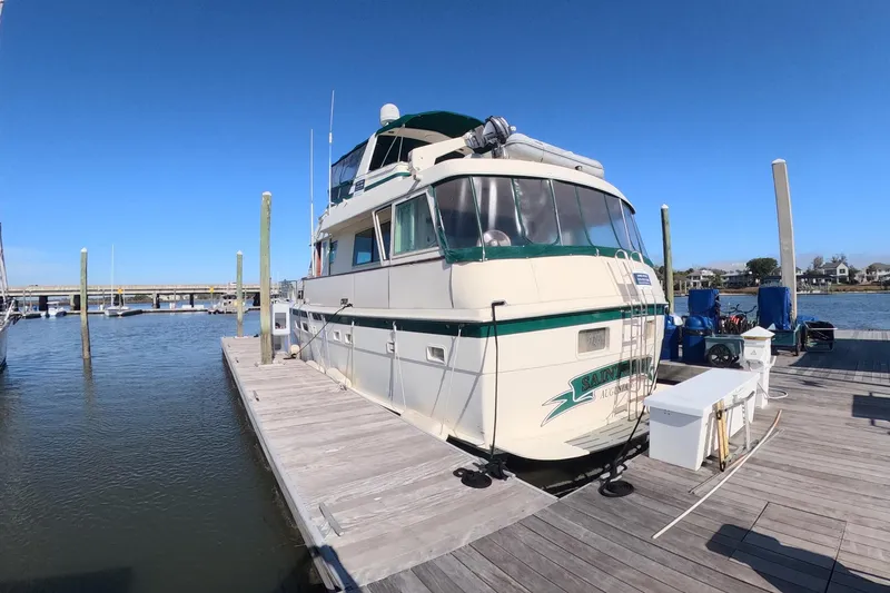 Saint Paul Yacht Photos Pics 1987 Hatteras 54 Motor Yacht docked at marina under clear blue sky.