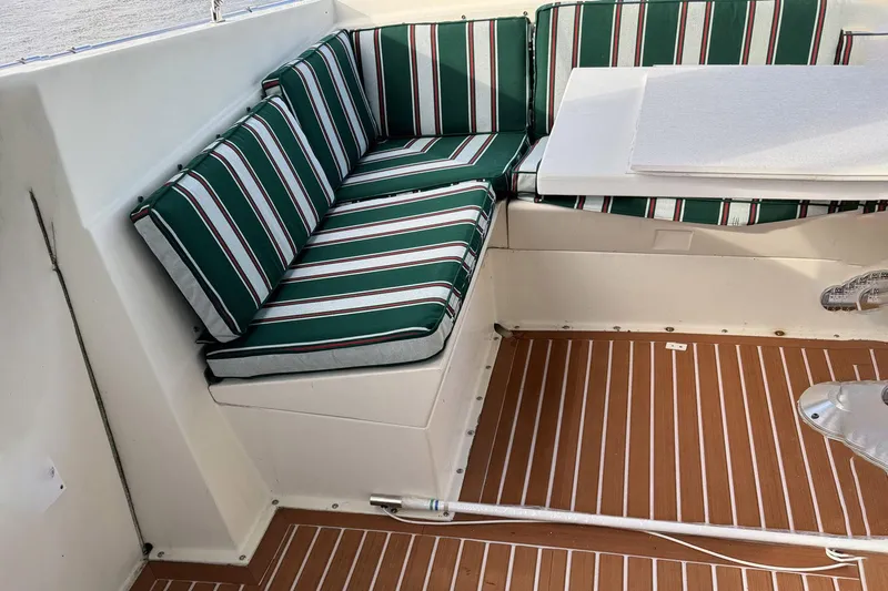 Saint Paul Yacht Photos Pics 1987 Hatteras 54 Motor Yacht interior with striped seating and wooden flooring.