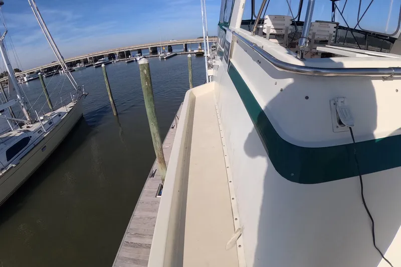 Saint Paul Yacht Photos Pics 1987 Hatteras 54 Motor Yacht docked at marina, clear sky, calm water.
