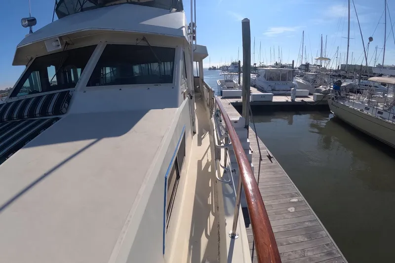 Saint Paul Yacht Photos Pics 1987 Hatteras 54 Motor Yacht docked at marina, sunny day, clear sky, calm water.