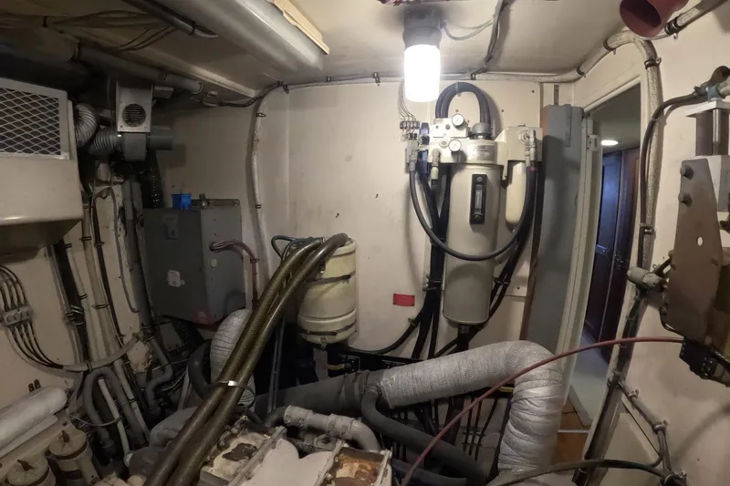 Saint Paul Yacht Photos Pics Engine room of a 1987 Hatteras 54 Motor Yacht, showcasing mechanical components and wiring.