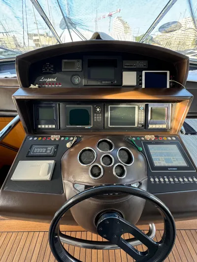 Mazag Yacht Photos Pics Control panel of a 2007 Arno Leopard 27 yacht with navigation instruments and steering wheel.