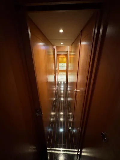 Mazag Yacht Photos Pics Narrow hallway inside 2007 Arno Leopard 27 yacht, featuring polished wood paneling and sleek design.