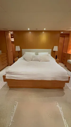 Mazag Yacht Photos Pics Luxurious bedroom interior of 2007 Arno Leopard 27 yacht with modern furnishings.