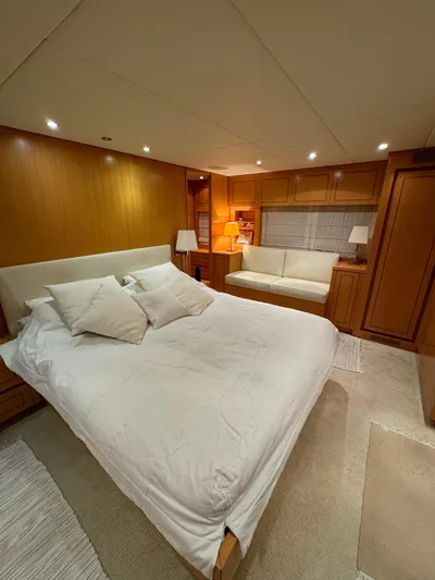 Mazag Yacht Photos Pics Luxurious bedroom interior of 2007 Arno Leopard 27 yacht with elegant wood paneling.
