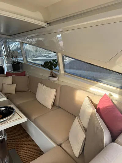 Mazag Yacht Photos Pics Luxurious interior of 2007 Arno Leopard 27 yacht with beige seating and decorative pillows.