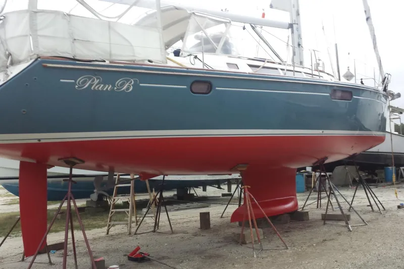 Yacht Photos Pics 2009 Jeanneau Sun Odyssey 44i sailboat "Plan B" on stands, blue hull, red keel.