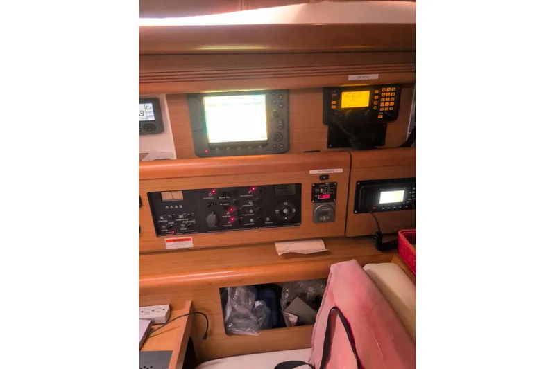  Yacht Photos Pics Control panel of a 2009 Jeanneau Sun Odyssey 44i sailboat, featuring navigation and communication equipment.