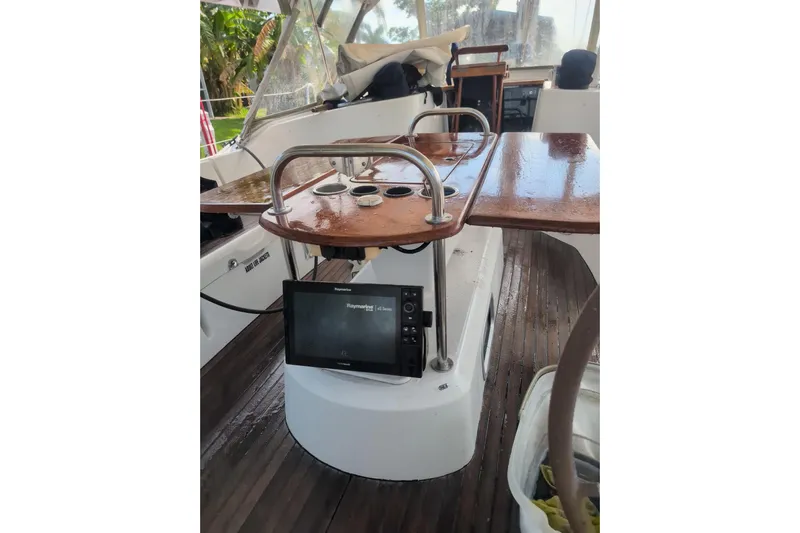  Yacht Photos Pics Cockpit of 2009 Jeanneau Sun Odyssey 44i with navigation equipment and wooden table.