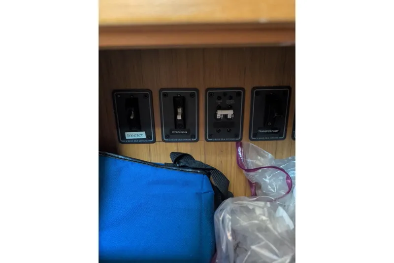  Yacht Photos Pics Control panel on 2009 Jeanneau Sun Odyssey 44i yacht, featuring switches for freezer, refrigerator, and transfer pump.