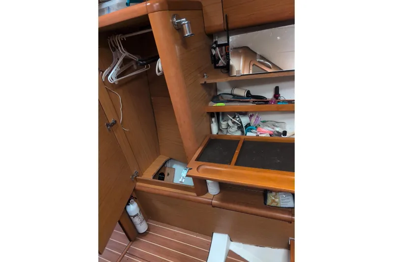  Yacht Photos Pics Interior of 2009 Jeanneau Sun Odyssey 44i with wooden cabinetry and storage shelves.
