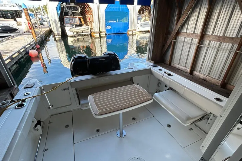  Yacht Photos Pics 2016 Boston Whaler 315 Conquest Pilothouse boat interior with table and seating.
