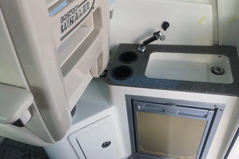  Yacht Photos Pics 2016 Boston Whaler 315 Conquest Pilothouse interior with sink and storage.