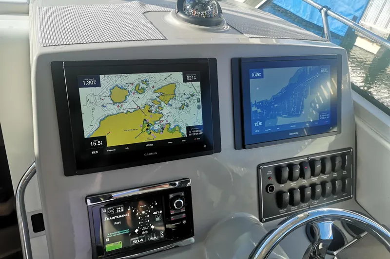  Yacht Photos Pics 2016 Boston Whaler 315 Conquest Pilothouse dashboard with navigation screens and controls.