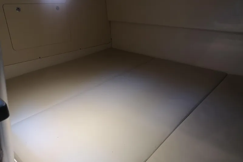  Yacht Photos Pics Interior cabin of 2016 Boston Whaler 315 Conquest Pilothouse, featuring a cushioned sleeping area.