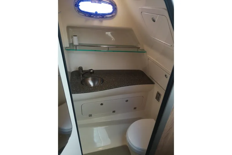  Yacht Photos Pics 2016 Boston Whaler 315 Conquest Pilothouse bathroom with sink, toilet, and storage.