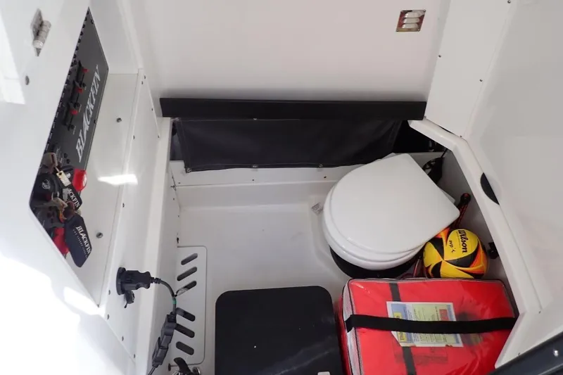  Yacht Photos Pics 2022 Blackfin 272 CC interior with toilet, storage, and control panel.