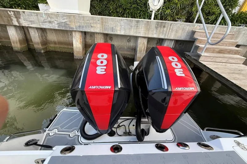  Yacht Photos Pics Twin Mercury 300 engines on a 2022 Blackfin 272 CC boat docked by water.