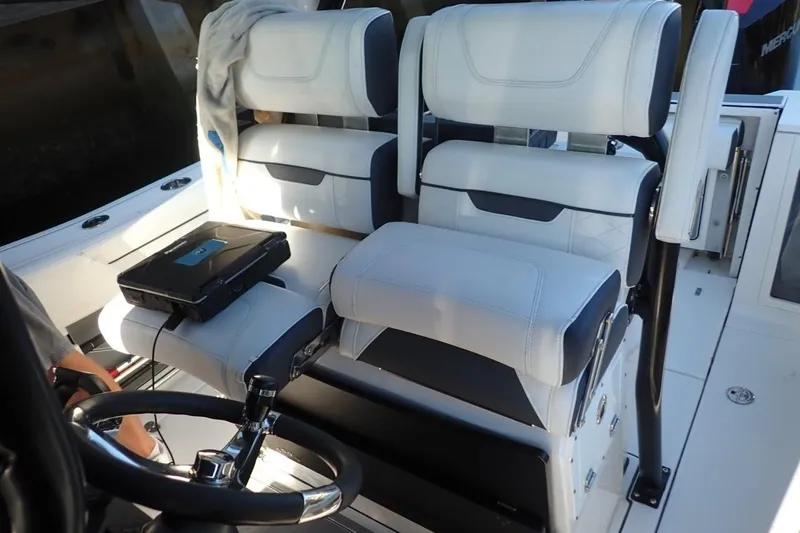  Yacht Photos Pics 2022 Blackfin 272 CC boat interior with dual helm seats and steering wheel.