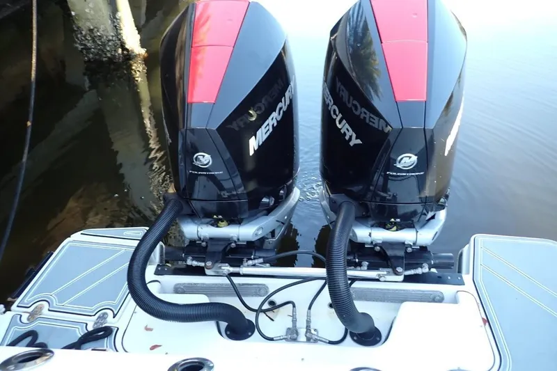  Yacht Photos Pics Twin Mercury outboard engines on a 2022 Blackfin 272 CC boat, docked by the water.