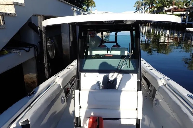  Yacht Photos Pics 2022 Blackfin 272 CC boat docked, featuring sleek design and spacious seating.