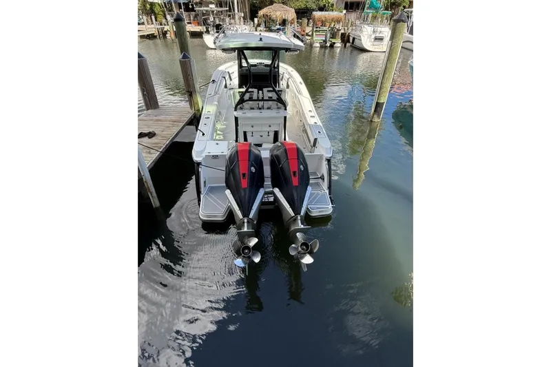  Yacht Photos Pics 2022 Blackfin 272 CC boat docked with dual outboard engines.