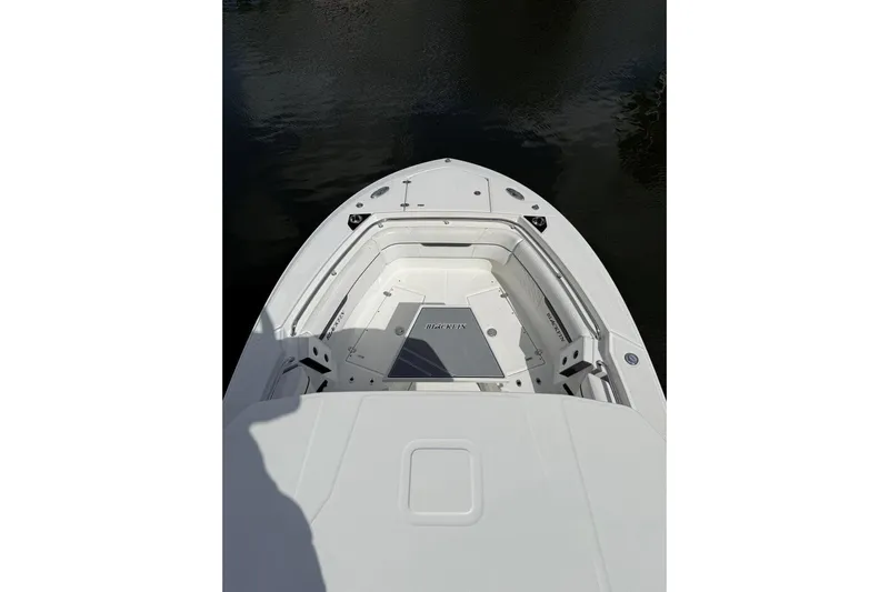 Yacht Photos Pics 2022 Blackfin 272 CC boat bow view, featuring sleek white design on calm water.