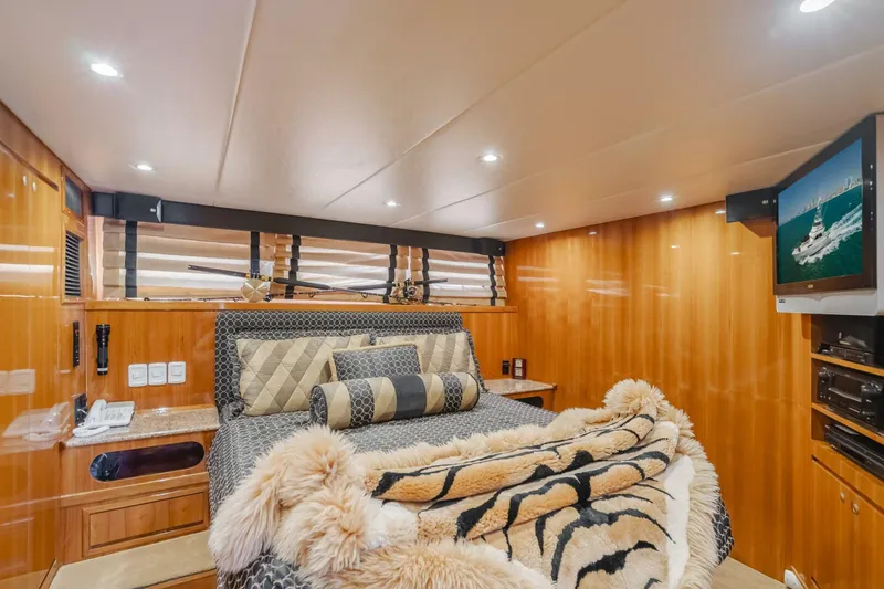 Fan Tail I Yacht Photos Pics Luxurious bedroom interior of 1988 Cheoy Lee 70 Enclosed Flybridge yacht with plush bedding.