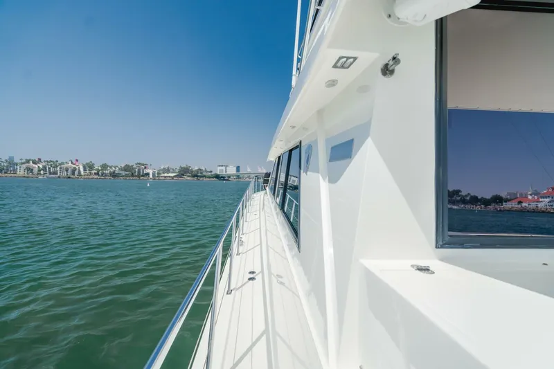 Fan Tail I Yacht Photos Pics 1988 Cheoy Lee 70 Enclosed Flybridge yacht cruising on calm waters.